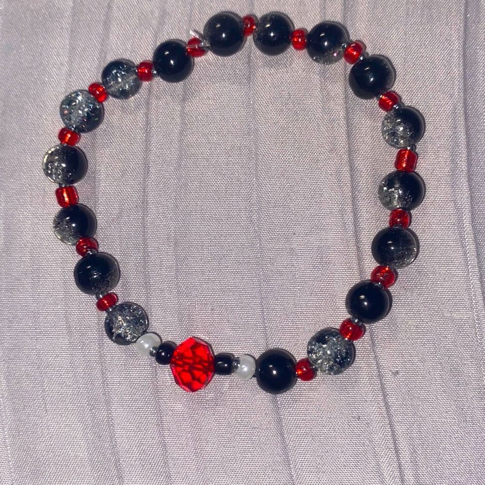 grey and red bracelet on 0.5mm string